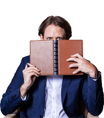 Travis Cody holding a book in front of his face