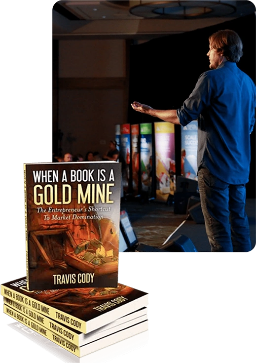 Travis Cody speaking on stage, with copies of his book When A Book Is A Gold Mine